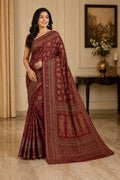 Maroon patterned saree with wide woven border and draped pleats