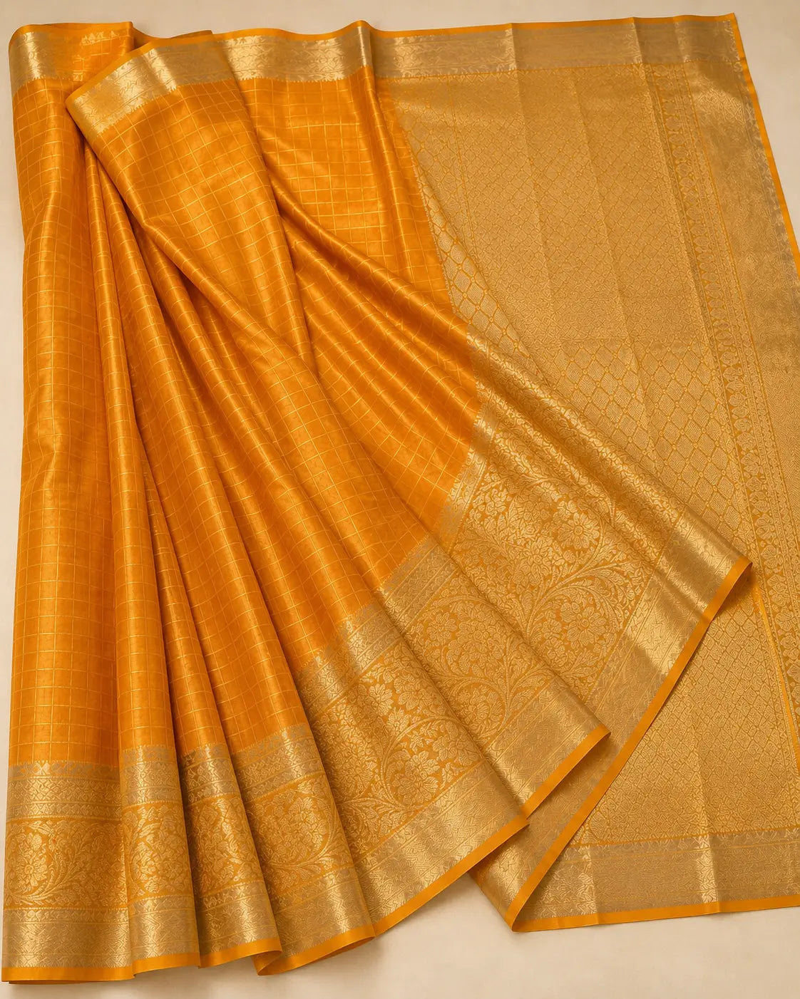 Draped mustard silk saree with shimmering gold finish and woven border