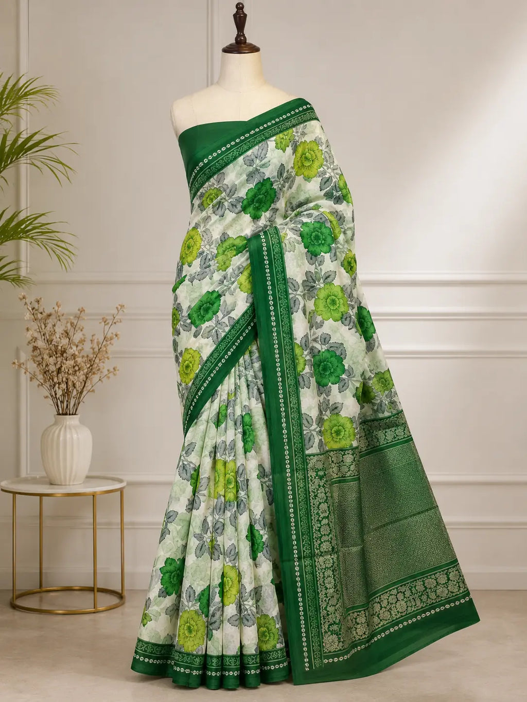 Green cotton saree draped on mannequin with leafy floral print and green border